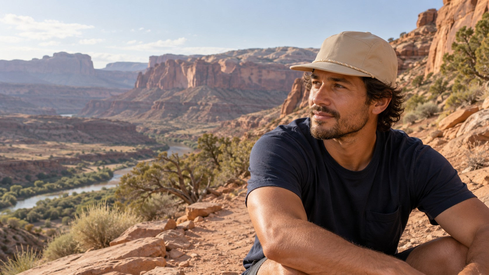 Man wearing a hat beside a desert trail